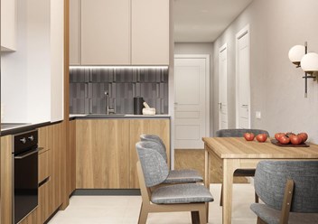 Красивая двухцветная кухня со встроенной техникой и скрытыми ручками.